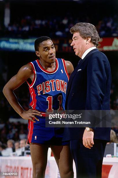 Chuck Daly, head coach of the Detroit Pistons has a few words with Isiah Thomas during a break in the action against the Los Angeles Lakers during a...