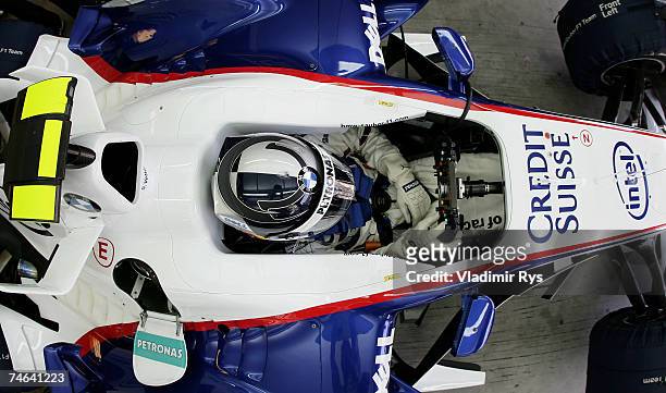 Sebastian Vettel of Germany and BMW Sauber sits in his car in the garage during practice for the F1 Grand Prix of USA at the Indianapolis Motor...