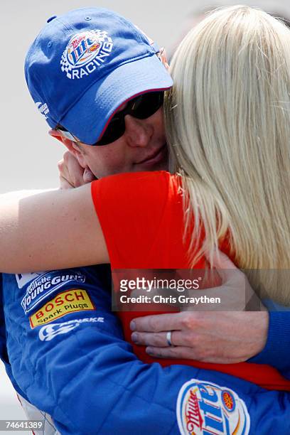 Kurt Busch, driver of the Miller Lite Dodge, hugs his wife Eva, during qualifying for the NASCAR Nextel Cup Series Citizens Bank 400 at Michigan...