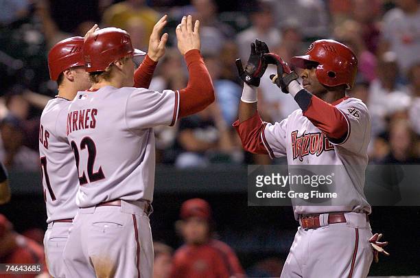 Orlando Hudson of the Arizona Diamondbacks is congratulated by Eric Byrnes and Mark Reynolds after hitting a pinch-hit home run in the eighth inning...