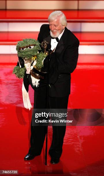 Actor/puppeteer Caroll Spinney with "Oscar the Grouch" accepts the Emmy for "Outstanding Performer in a Children's Series" onstage during the 34th...