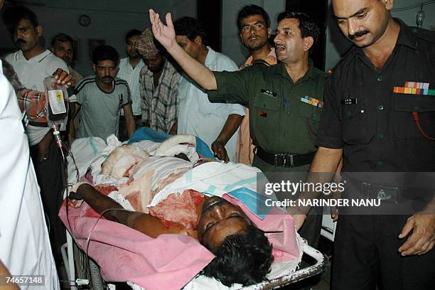 Indian Army personnel move injured man, Paramjit Singh on a stretcher, after a crude bomb exploded at a garbage dumping area in army cantonment, at a...