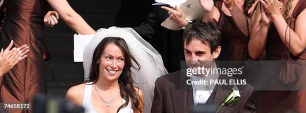Manchester, UNITED KINGDOM: Manchester United and England footballer Gary Neville and his wife Emma Hadfield leave Manchester's Cathedral, north west...