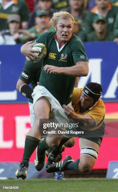 Schalk Burger of South Africa powers away from Dan Vickerman of Australia during the 2007 Tri Nations match between South Africa and Australia at...