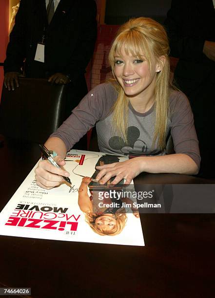 Hilary Duff autographs one of her " The Lizzie Mcguire Movie" posters at the The Disney Store Fifth Avenue in New York City, New York