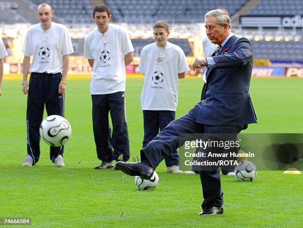 Prince of Wales kicks a penalty during a visit to Newcastle United's St James' Park ground on November 8, 2006. The Royal couple are on a two-day...