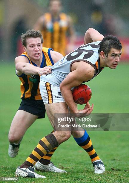 Josh Kennedy of the Hawks is tackled by Shane Valenti of Sandringham during the round 10 VFL match between Sandringham and the Box Hill Hawks at...