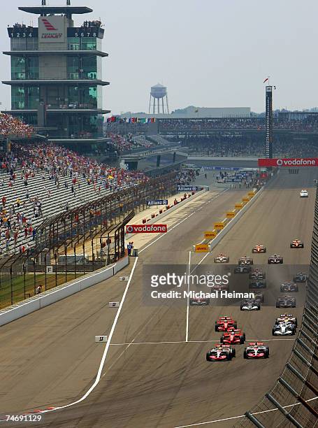 Lewis Hamilton of Great Britain and McLaren Mercedes leads the pack to start the F1 Grand Prix of USA at the Indianapolis Motor Speedway on June 17,...