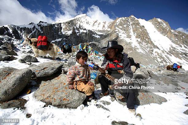 Tibetan nomads rest on their journey to the snow-capped Kangrinboqe Mountain, known as Mt. Kailash in the West, June 16, 2007 in Purang County of...