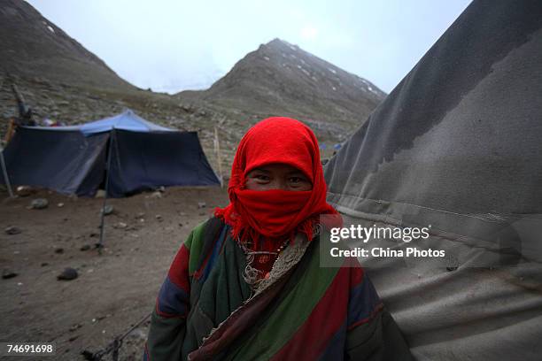 Religious faithful pray at the snow-capped Kangrinboqe Mountain, known as Mt. Kailash in the West, June 15, 2007 in Purang County of Tibet Autonomous...