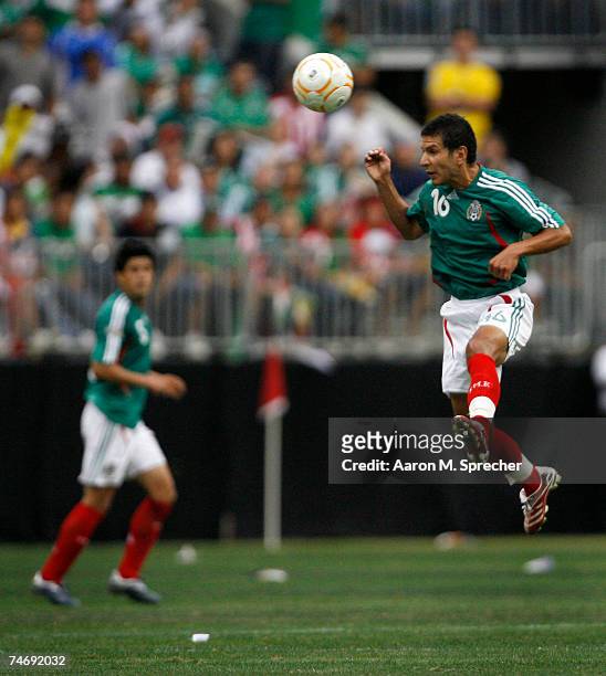 Jaime Lozano of Mexico passes the ball with his head against Costa Rica during their quarterfinal match of the CONCACAF Gold Cup 2007 tournament on...