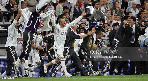 Real Madrid's David Beckham and Italian coach Fabio Capello celebrate with teammates after Real won the Spanish league title by beating Mallorca in...