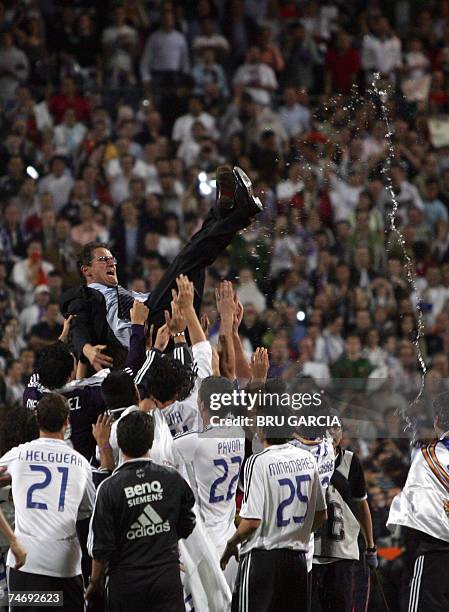 Real Madrid's Italian coach Fabio Capello is thrown in the air after Real won the Spanish league title by beating Mallorca in the final Spanish...