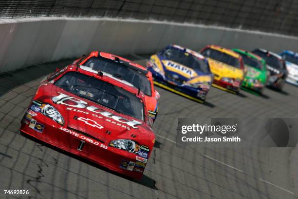 Dale Earnhardt Jr., driver of the Budweiser Chevrolet, leads a line of cars during the NASCAR Nextel Cup Series Citizens Bank 400 at Michigan...