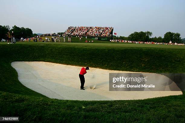 Tiger Woods hits out of a bunker on the 17th hole during the final round of the 107th U.S. Open Championship at Oakmont Country Club on June 17, 2007...