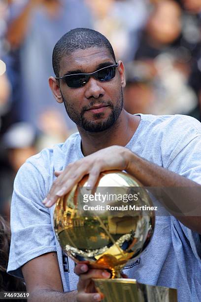 Tim Duncan of the San Antonio Spurs holds the Larry O'Brien trophy during the NBA championship parade down the San Antonio River walk June 17, 2007...