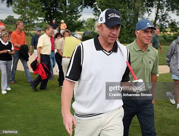 Boris Becker and Franz Beckenbauer walk during the opening of Hartl Golf Resort on June 18 in Penning, Germany.