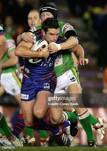 Danny Buderus of the Knights is tackled during the round 14 NRL match between the Newcastle Knights and the Canberra Raiders at EnergyAustralia...