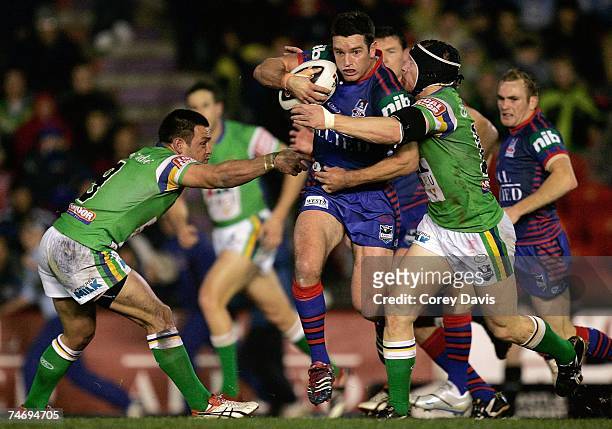 Danny Buderus of the Knights is tackled during the round 14 NRL match between the Newcastle Knights and the Canberra Raiders at EnergyAustralia...