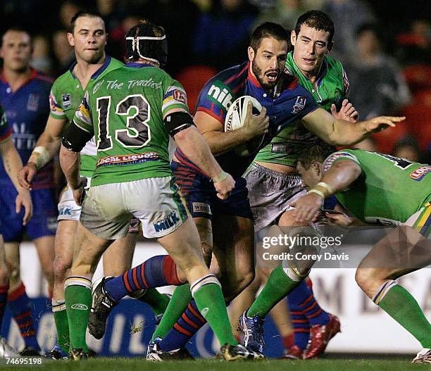 Adam Woolnough of the Knights runs the ball at the Raiders defence during the round 14 NRL match between the Newcastle Knights and the Canberra...
