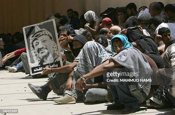 Holding a photograph of the late Palestinian leader Yasser Arafat, leader also of the Fatah movement, Palestinian families most of them supporters of...