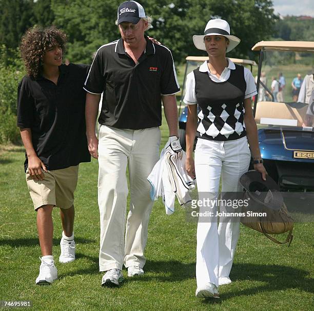 Boris Becker walks over the ground with his son Noah and his girlfriend Sharlely Lilly Kerssenberg during the opening of Hartl Golf Resort on June 18...