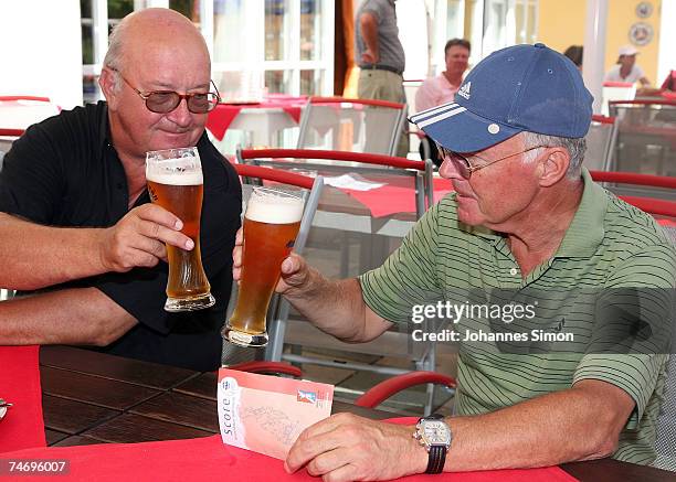 Franz Beckenbauer and Alois Hartl cheer after playing golf during the opening of Hartl Golf Resort on June 18 in Penning, Germany.