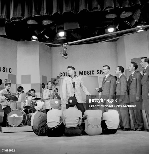 Elvis Presley rehearses for his performance on the Milton Berle Show on June 4 1956 with the Jordanaires and his backing group in Burbank,...