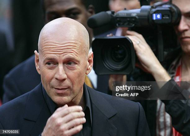 Actor Bruce Willis poses as he arrives for the German Premiere the film ?Live Free or Die Hard,? the 4th of the ?Die Hard? series by Len Wiseman and...