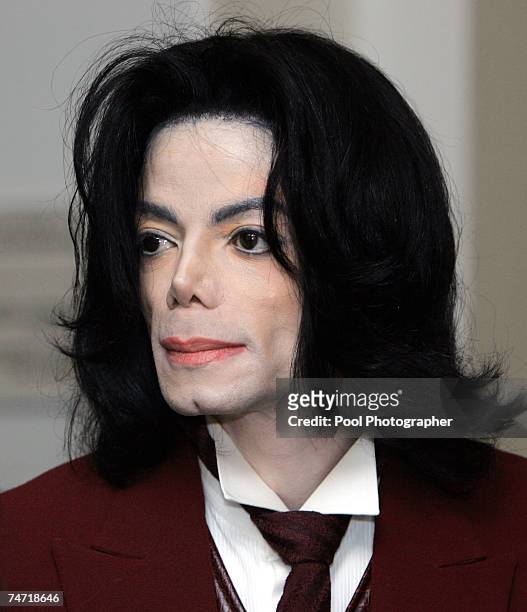 Michael Jackson re-enters the courtroom during a break at the Santa Barbara County courthouse April 27 in Santa Maria, California at his child...