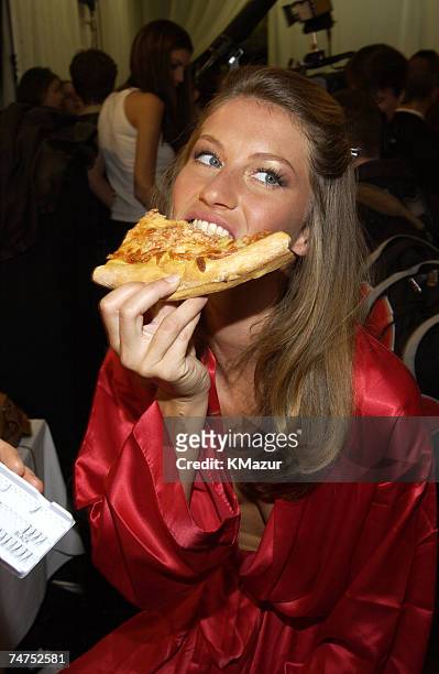Gisele Bundchen eats some pizza before the show at the The New York State Armory in New York City, New York