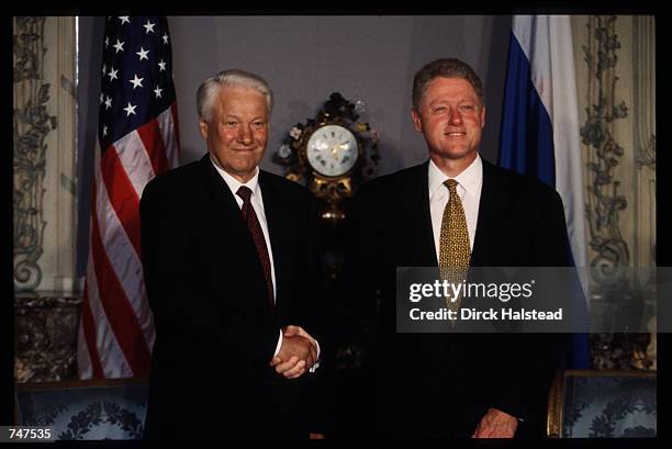 President Bill Clinton and Russian President Boris Yeltsin shake hands at the NATO Summit May 27, 1997 in Paris, France. The meeting resulted in the...