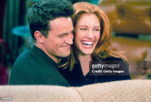 Actor Matthew Perry and actress Julia Roberts hug each other on the set of "Friends."