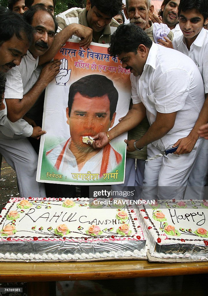 Indian Youth Congress supporters cut a h...