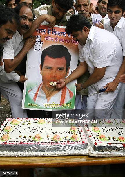 Indian Youth Congress supporters cut a huge birthday cake during celebrations for the 37th birthday of Rahul Gandhi, leader of the youth wing of the...