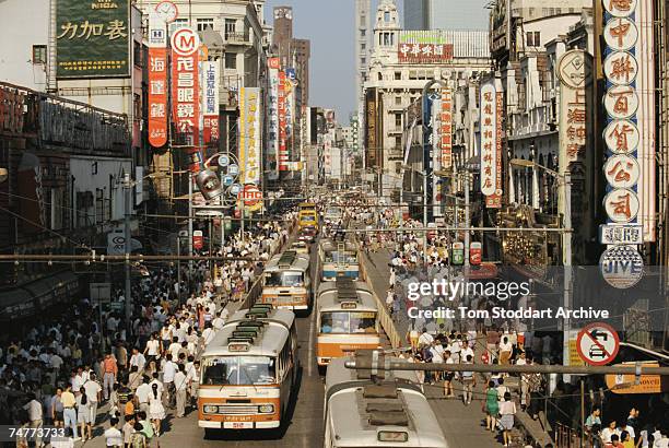 Traffic and crowds of people on the busy Nanjing Road in Shanghai, 1993.