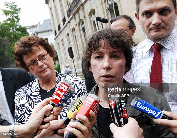 French minister for Housing and Urban Affairs Christine Boutin listens to her newly appointed junior minister for urban affairs Fadela Amara...