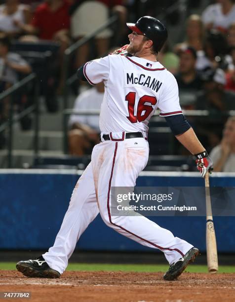Brian McCann of the Atlanta Braves hits a home run against the Boston Red Sox at Turner Field on June 18, 2007 in Atlanta, Georgia. The Braves...