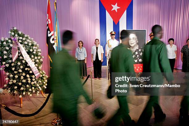 Cubans pass by a photo of Vilma Espin, wife of Cuba's acting President Raul Castro, is displayed in the Memorial Jose Marti, at the Revolution Square...