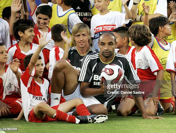 Guti and Emerson of Real Madrid pose with young players before a friendly match between Real Madrid and a Palestinian & Israeli XI at the Ramat Gan...
