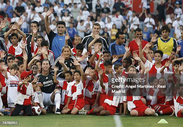 The Real Madrid team pose with children before the friendly match between Real Madrid and a Palestinian & Israeli XI at the Ramat Gan stadium on June...