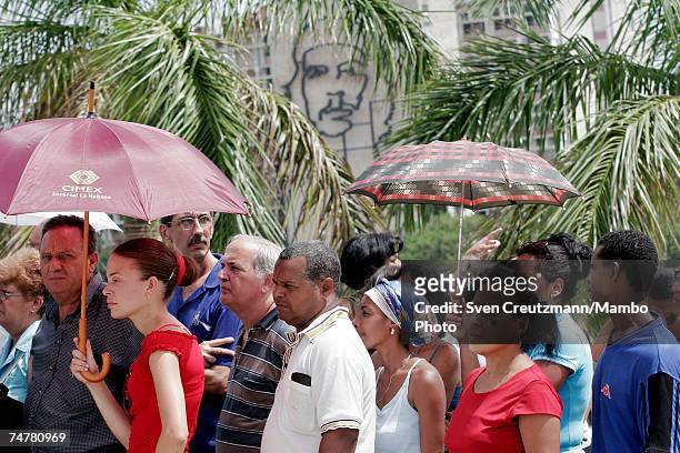 Cubans wait in line to pass by a photo of Vilma Espin, wife of Cuba's acting President Raul Castro, that is displayed in the Memorial Jose Marti, at...