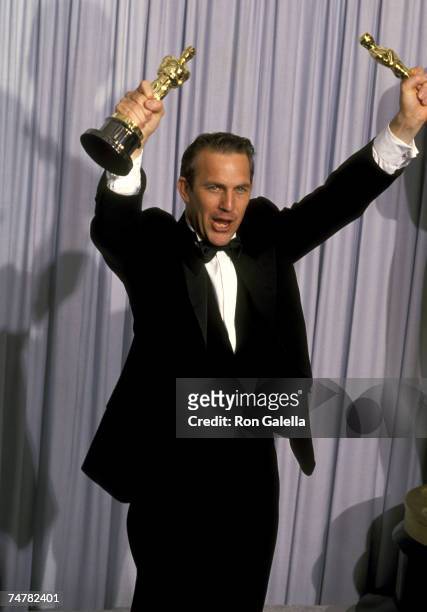 Kevin Costner, winner of Best Picture and Best Director for "Dances with Wolves" at the Shrine Auditorium in Los Angeles, California