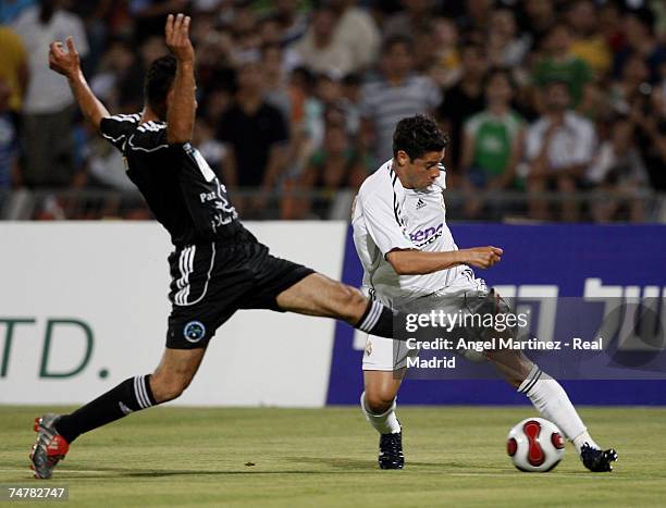 Cicinho of Real Madrid is challenged by a member of the Peace team during the friendly match between Real Madrid and a Palestinian & Israeli XI at...