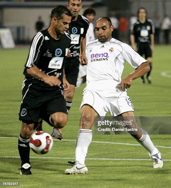 Israel Emerson of Real Madrid competes for the ball with a member of the Peace team during a friendly match between Real Madrid and a Palestinian &...