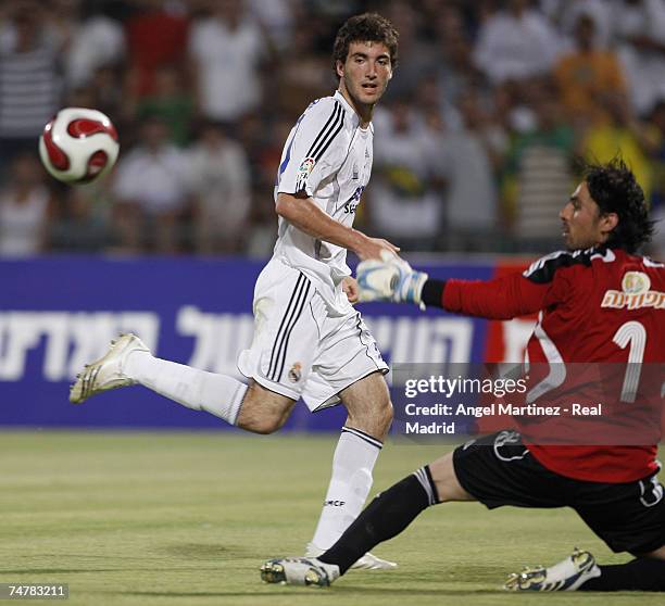 Israel Gonzalo Higuain of Real Madrid gets the ball past Dudu Awat of the Peace team during the friendly match between Real Madrid and a Palestinian...