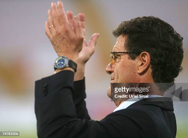 Real Madrid coach Fabio Capello applauds before the match between Real Madrid and a Palestinian & Israeli XI at the Ramat Gan stadium on June 19,...