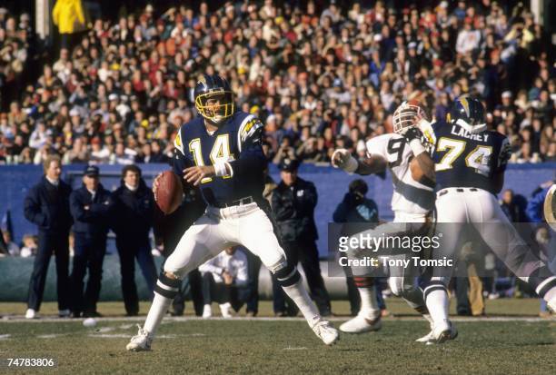 Quarterback Dan Fouts of the San Diego Chargers sets up to pass as offensive tackle Jim Lachey blocks defensive lineman Sam Clancy of the Cleveland...