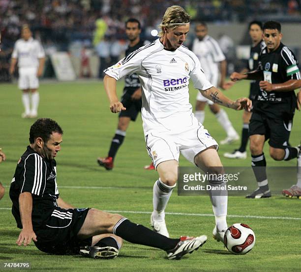 Guti of Real Madrid avoids a challenge from a member of the Peace Team during a friendly match between Real Madrid and a Palestinian & Israeli XI at...