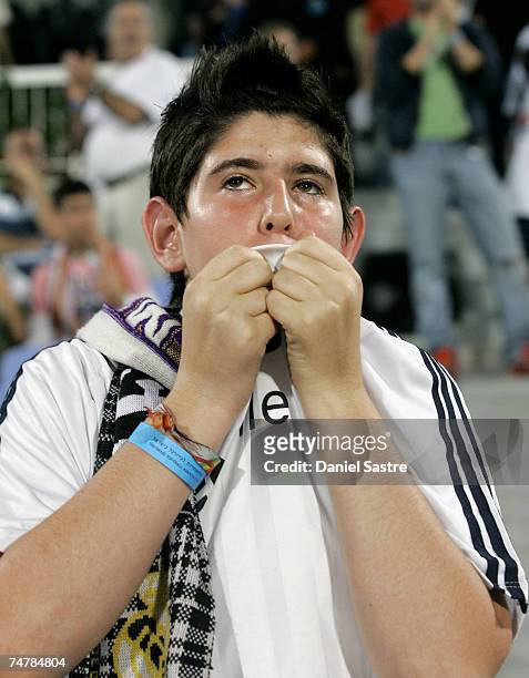 Real Madrid supporter kisses his shirt before a friendly match between Real Madrid and a Palestinian & Israeli XI at the Ramat Gan stadium on June...